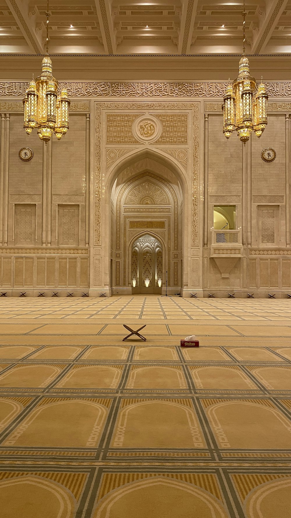 a large ornate room with a large chandelier and a tile floor