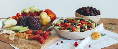 A colorful assortment of fresh fruits arranged on a rustic wooden table.