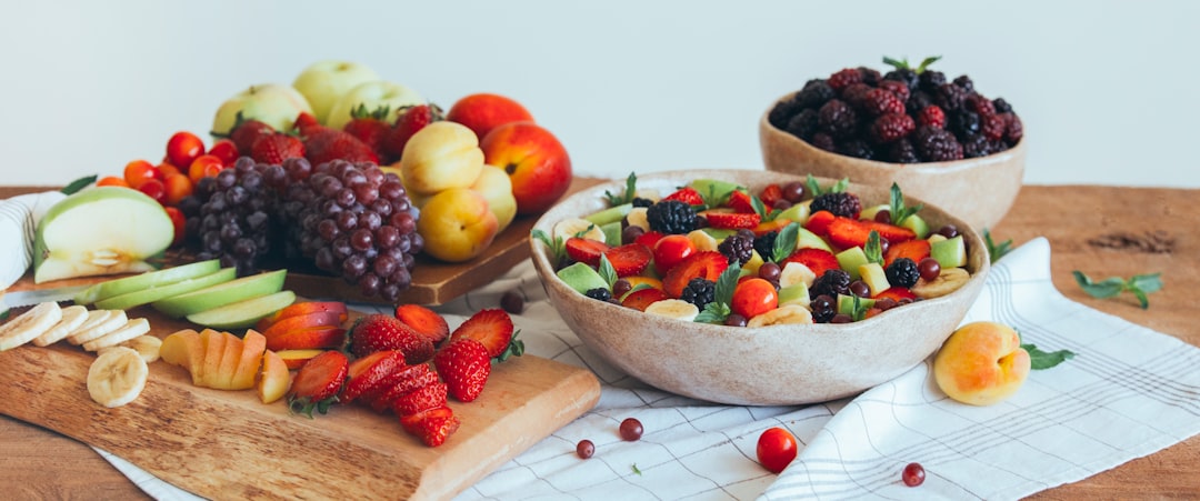 Healthy mixed fruit salad (Blackberry, banana, peach, nectarine, strawberry, apple, apricot, grape, min) on a crockery bowl, summer concept, healthy vitamins. Organic. Header.