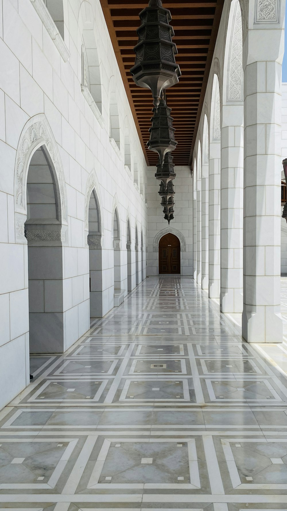 a hallway with a large black bell