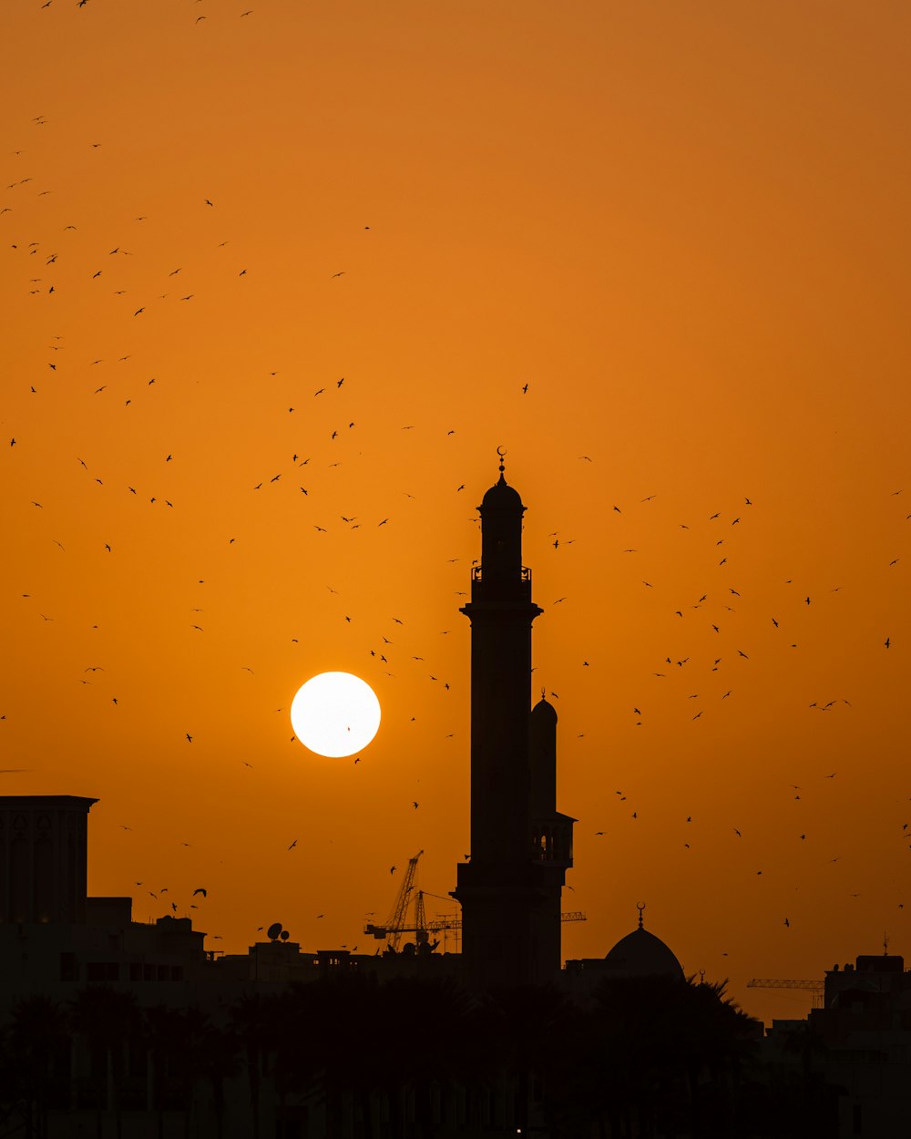 a large tower with a sunset in the background