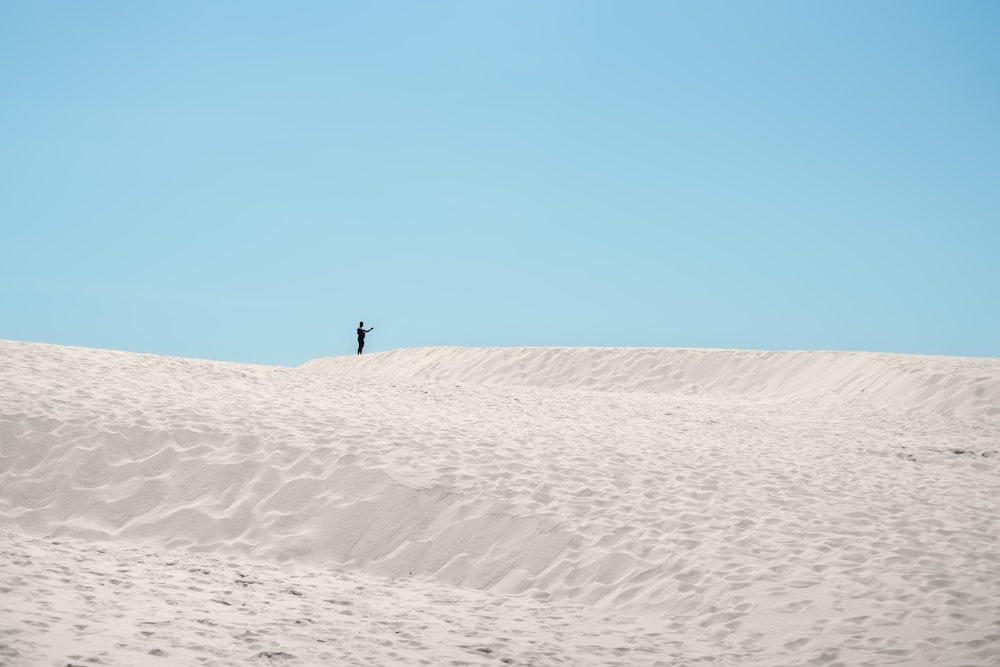 a person walking in the sand