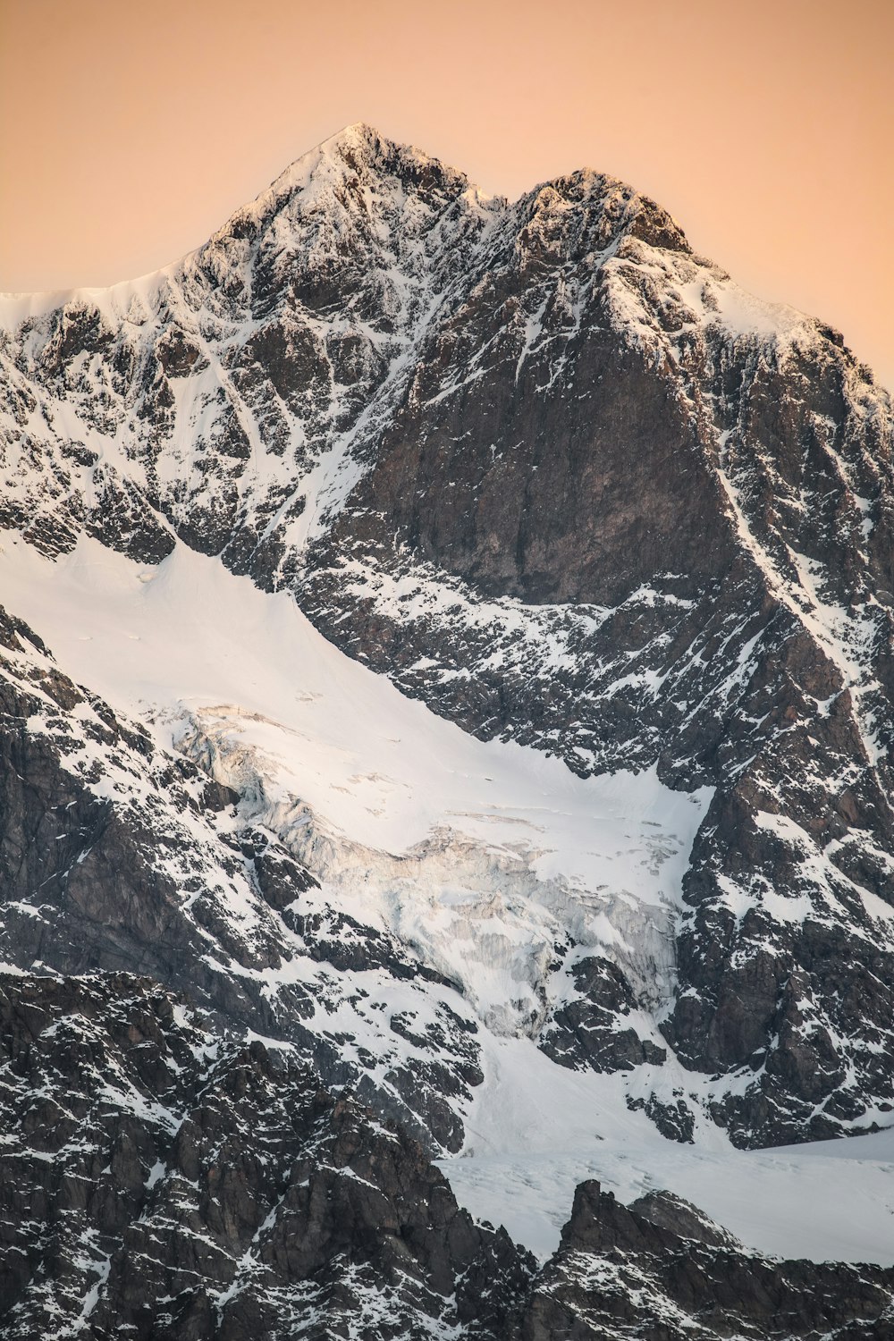 a snowy mountain with a sunset