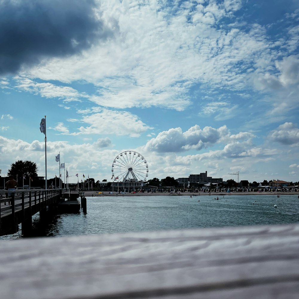 a ferris wheel by a body of water