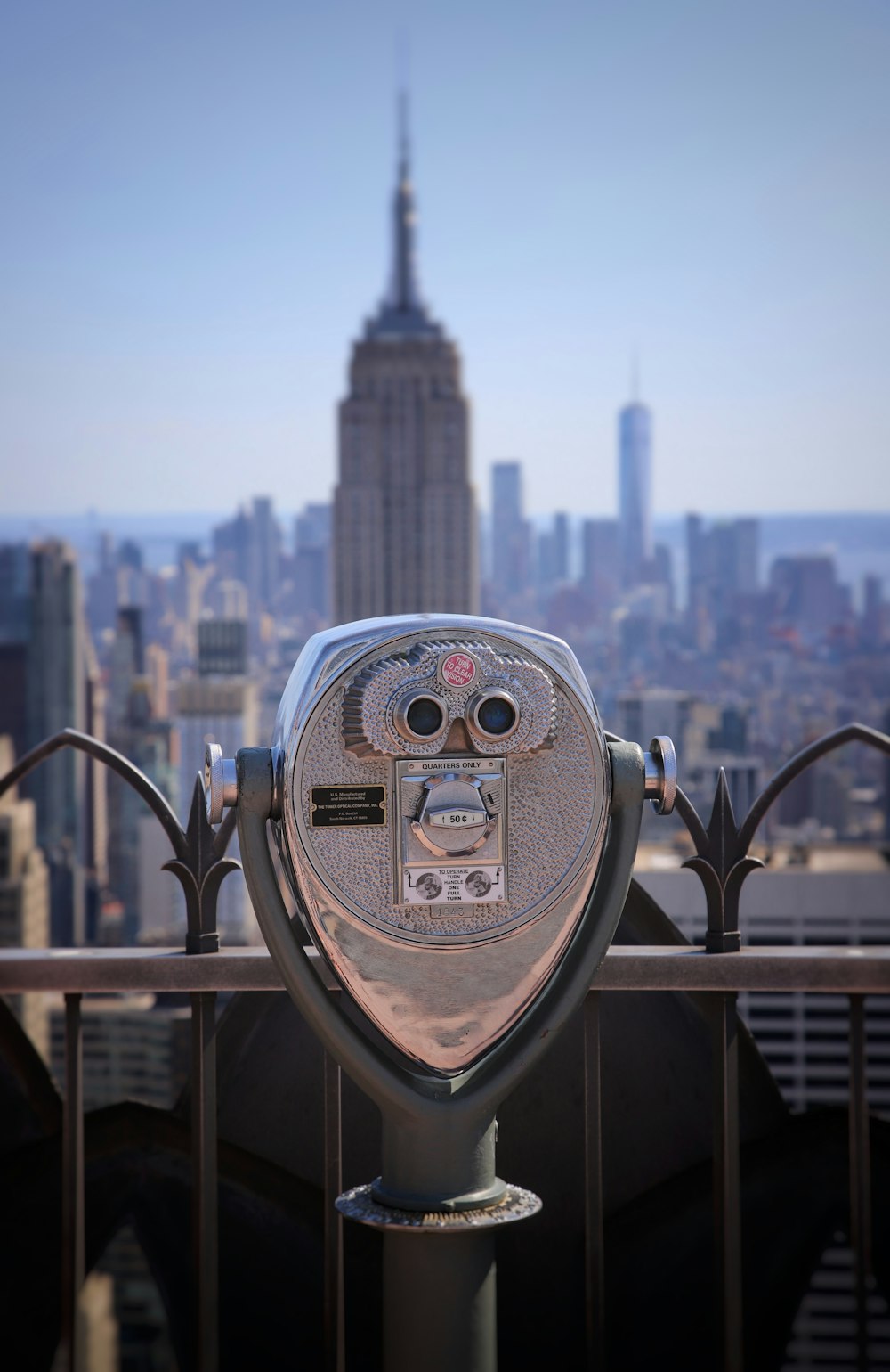 a metal object with a city in the background