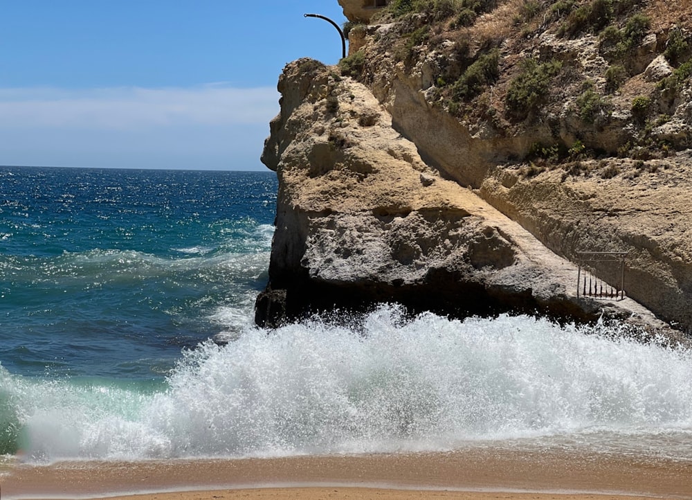 a rocky cliff next to the ocean