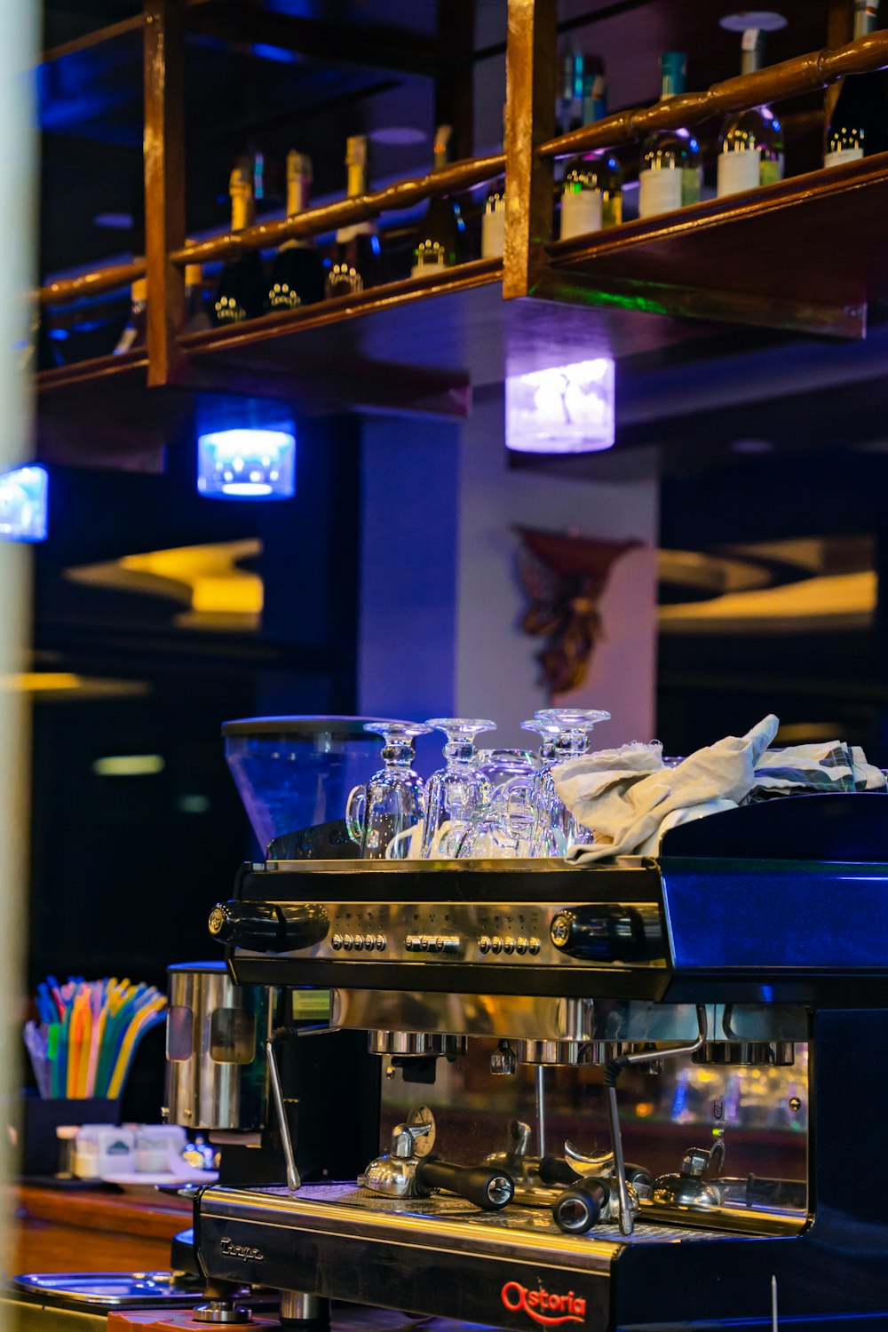 a bar with a large display of glasses and bottles of alcohol