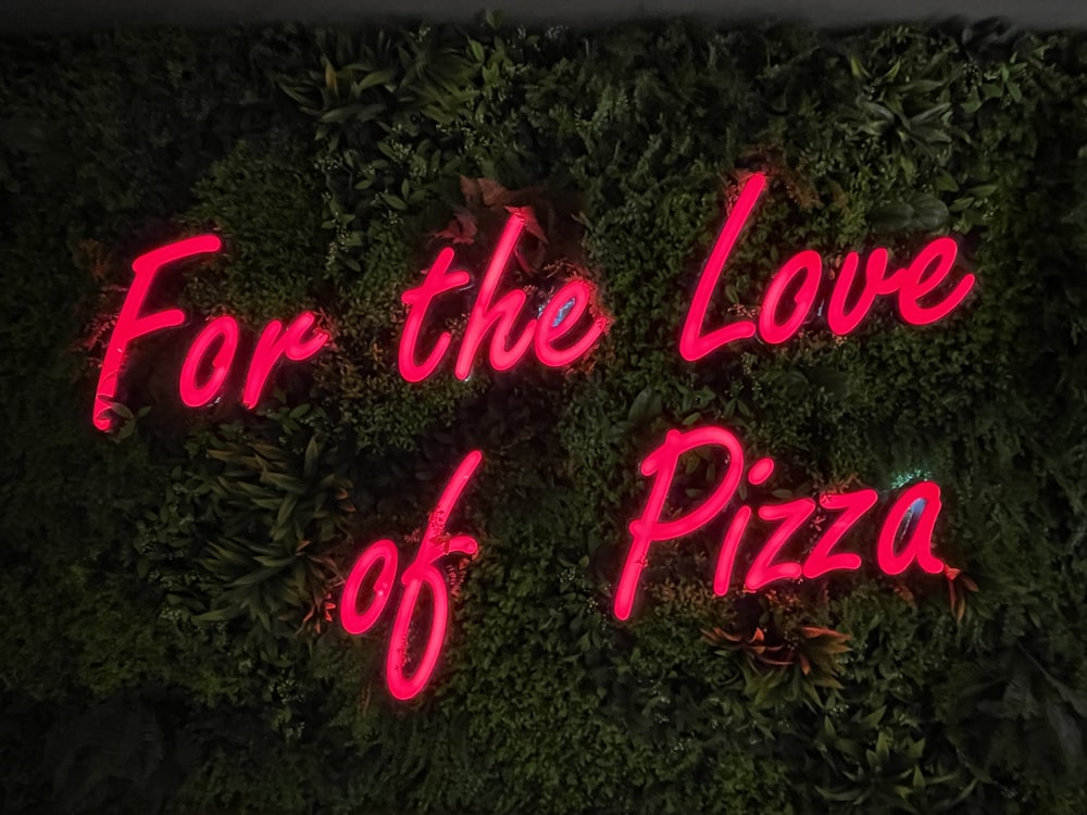 a group of pink text on a green plant