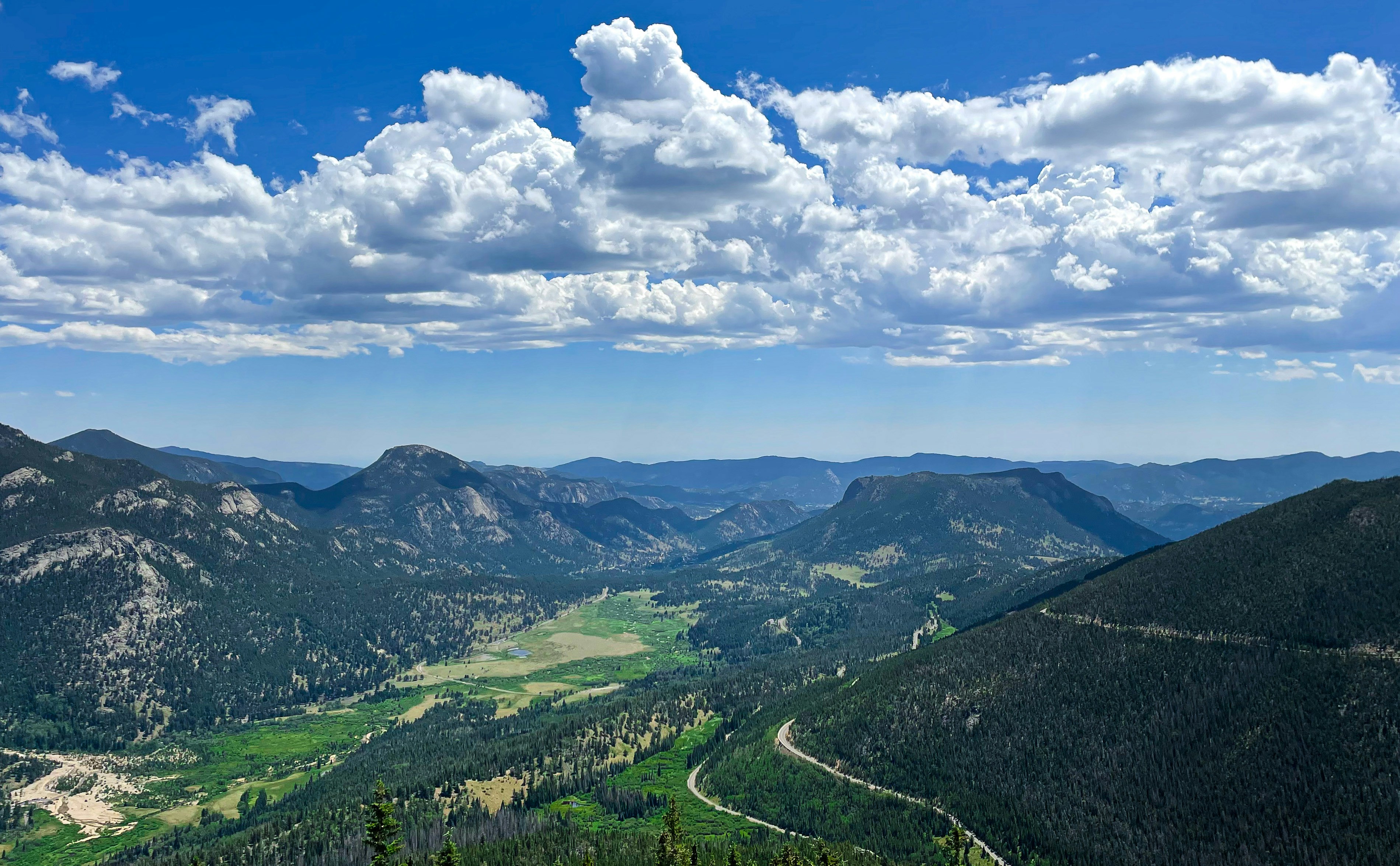 a landscape with mountains and clouds
