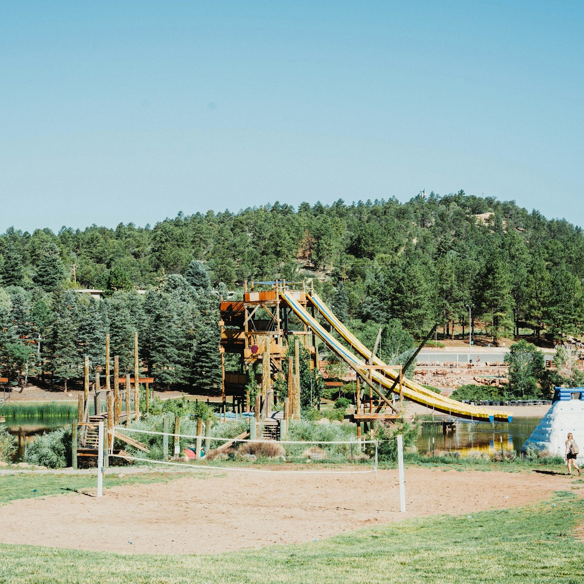 The Kids Konnection playground with trees behind it.