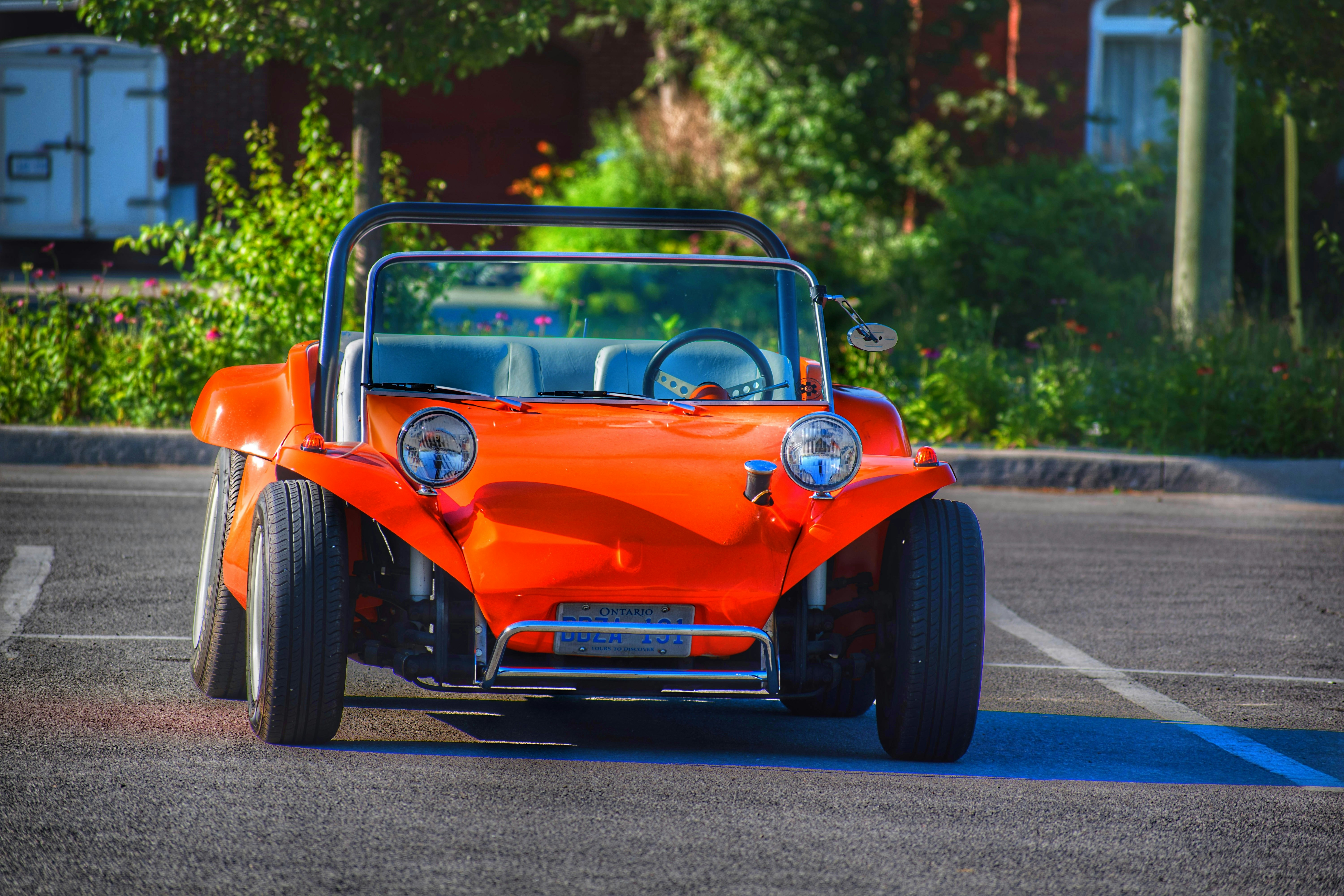 an orange car on a road