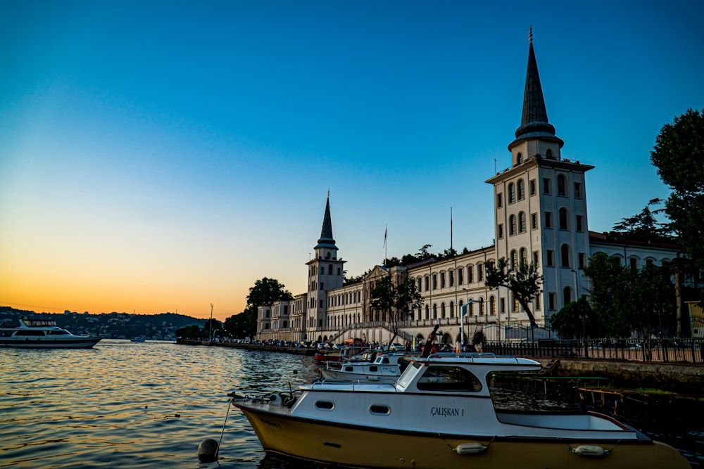 a boat in the water by a large building