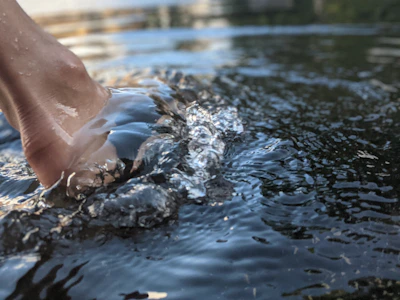 Close-up of gentle whirlpool water swirling around a foot in a medical hydrotherapy spa.