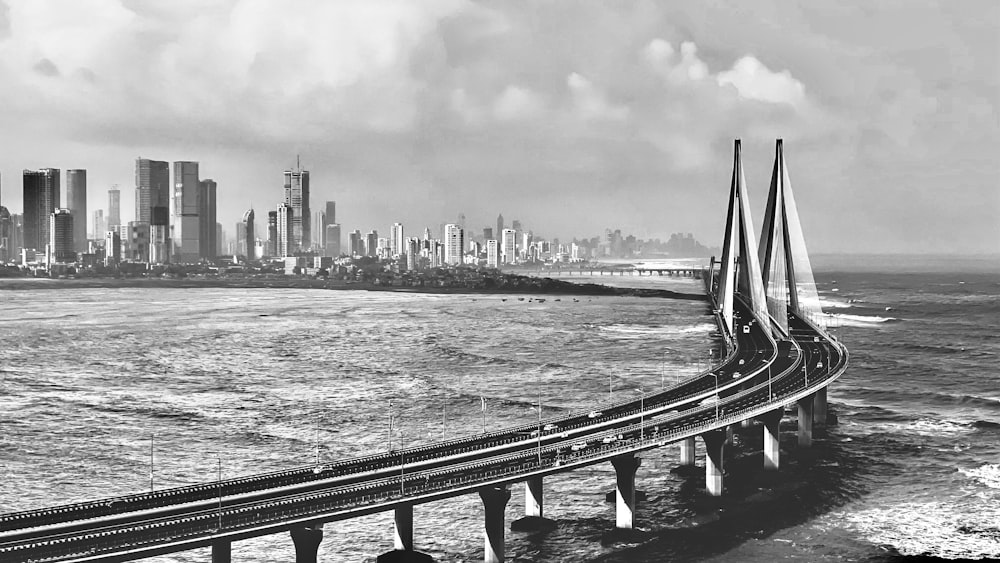 a bridge over water with a city in the background