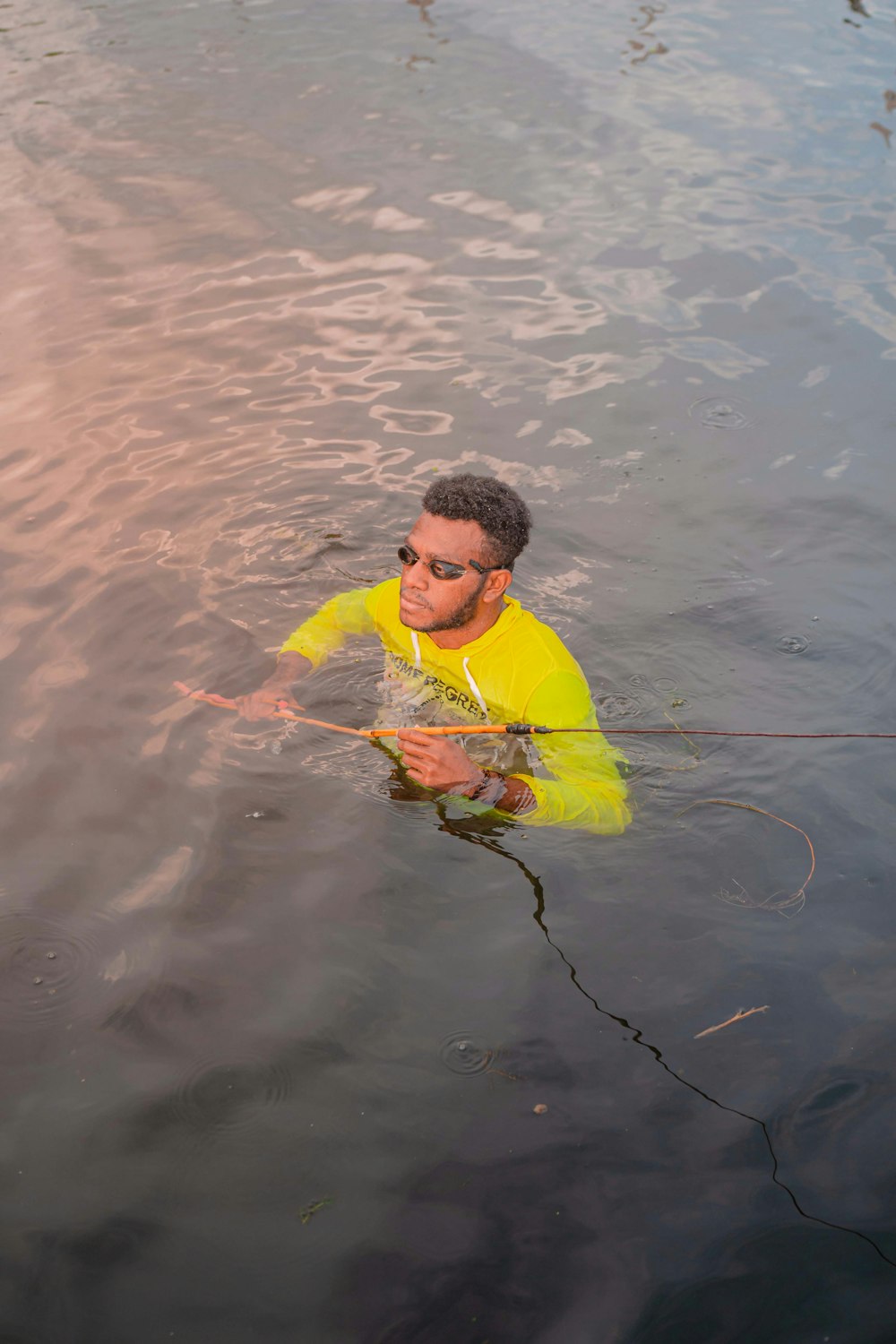 a man in a yellow jacket in water