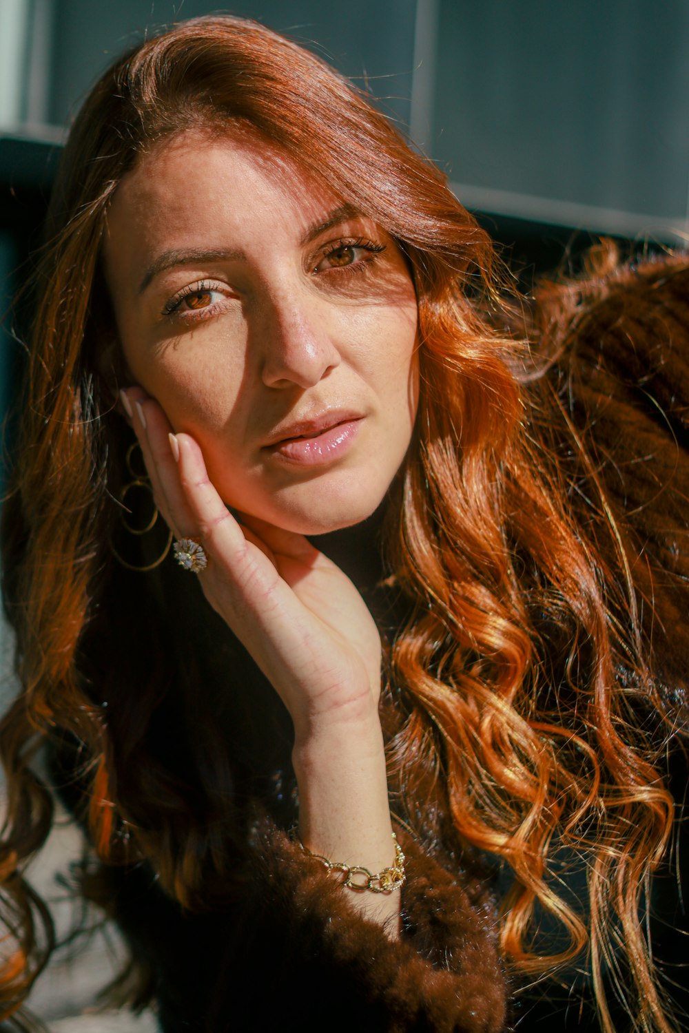 a woman with her hand on her face