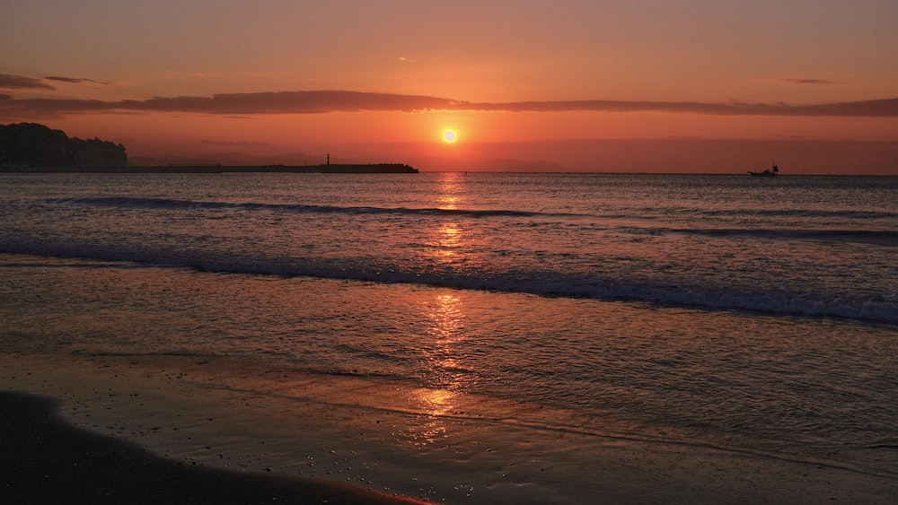 a beach with a sunset