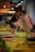 Two people, possibly participating in a painting workshop, are positioned near easels on a table that is set up for an art activity. The table is adorned with glasses containing a pinkish drink, paintbrushes, and art materials. Warm lighting adds a cozy ambiance to the setting.