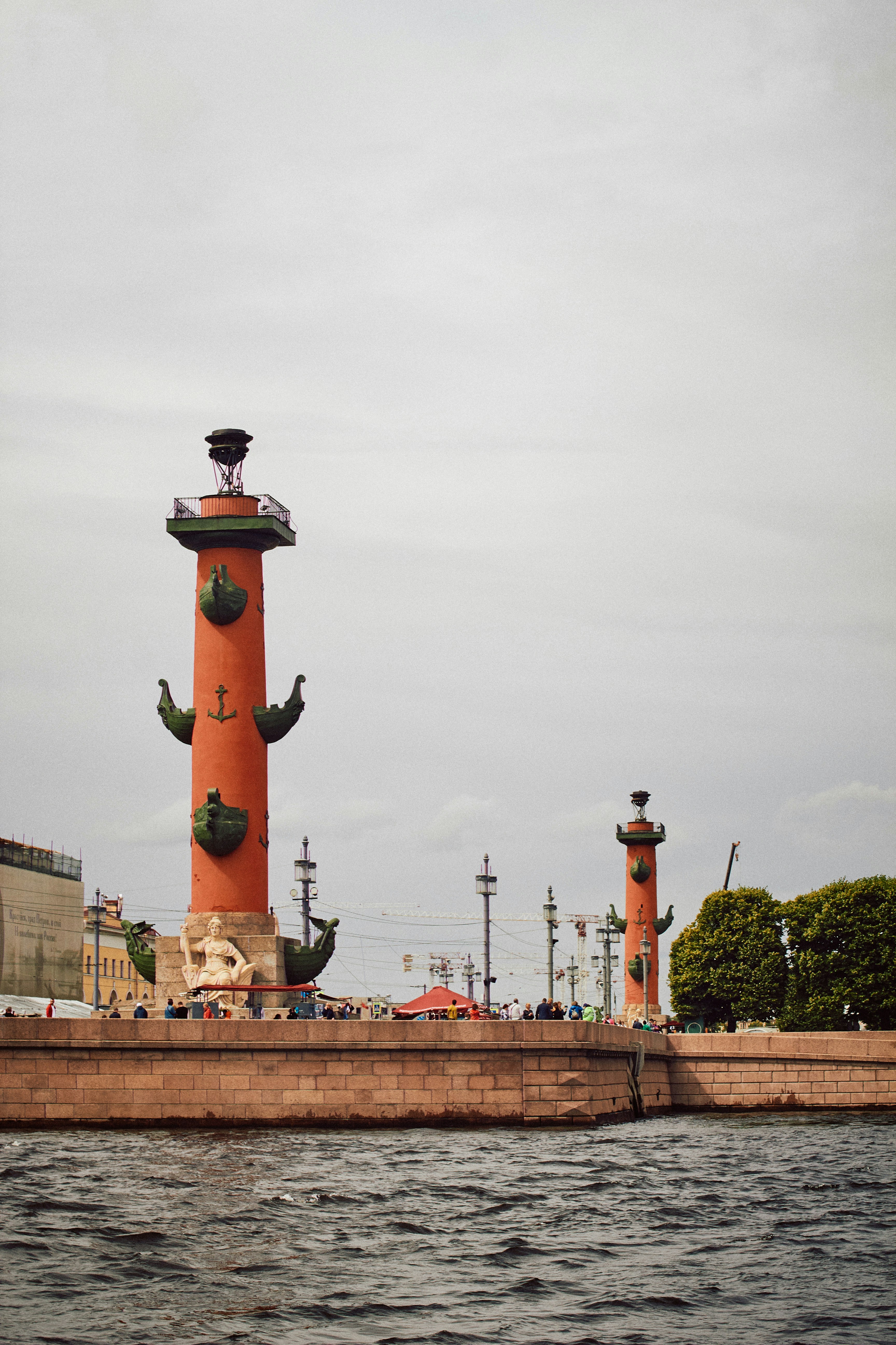 a large tower next to a body of water