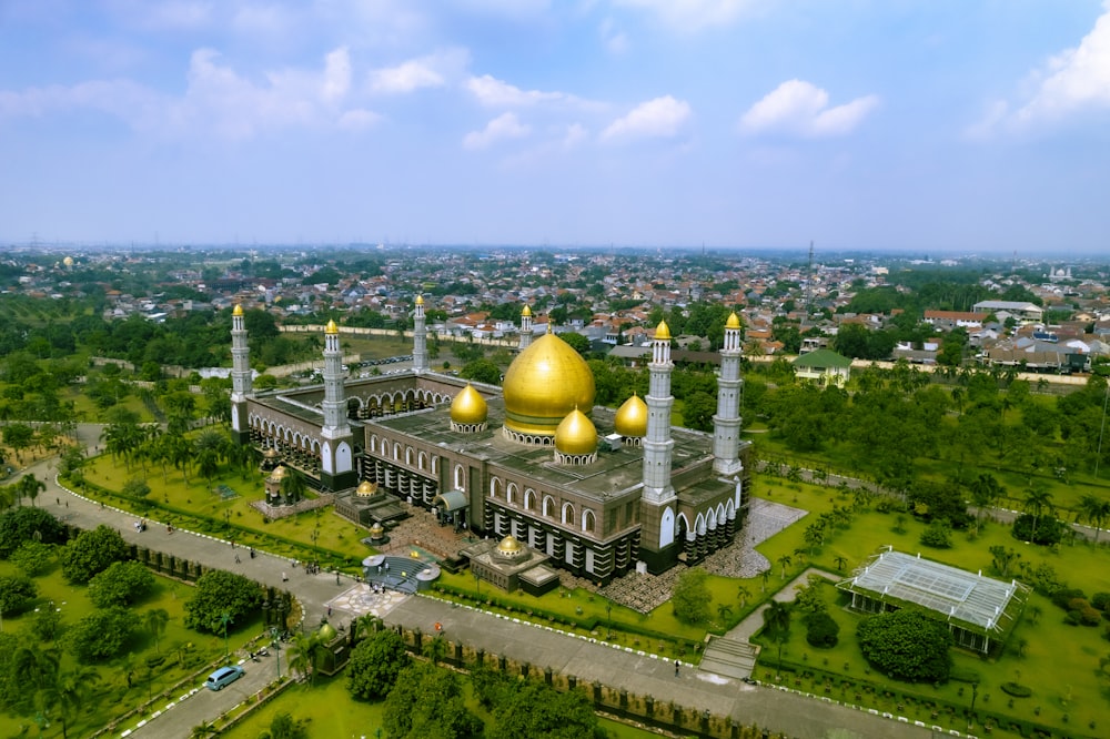 a building with a gold dome and towers surrounded by trees