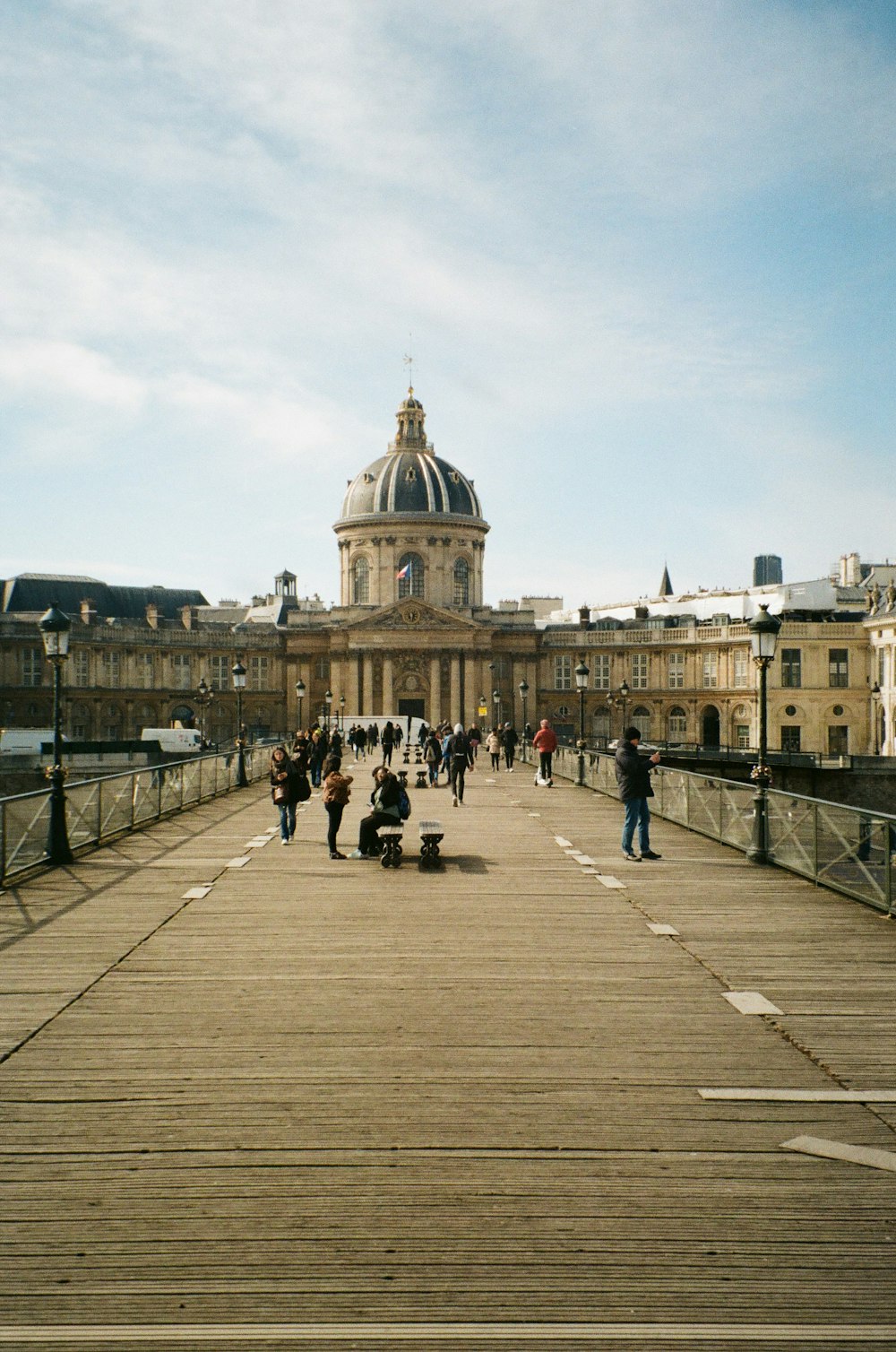 a group of people walking on a bridge