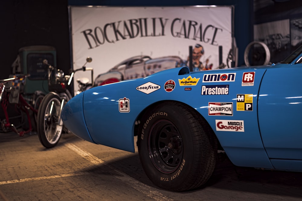 a blue car with a large tire