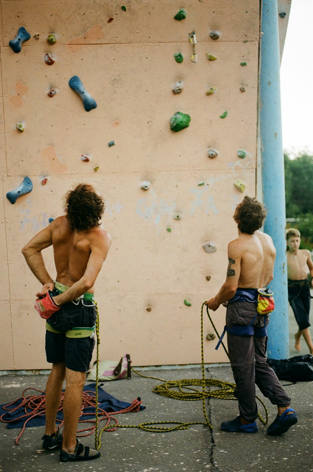 a group of men climbing a rock wall