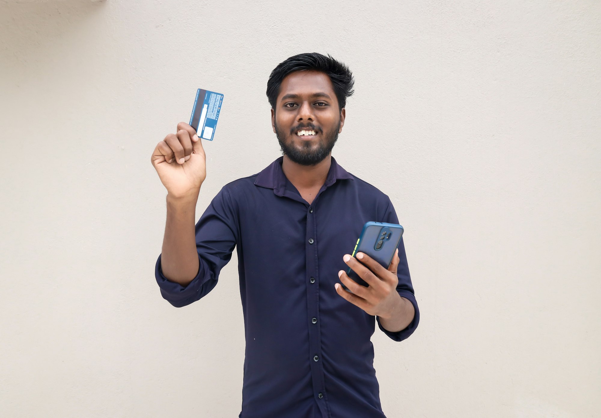 A man holding a atm card to pay 