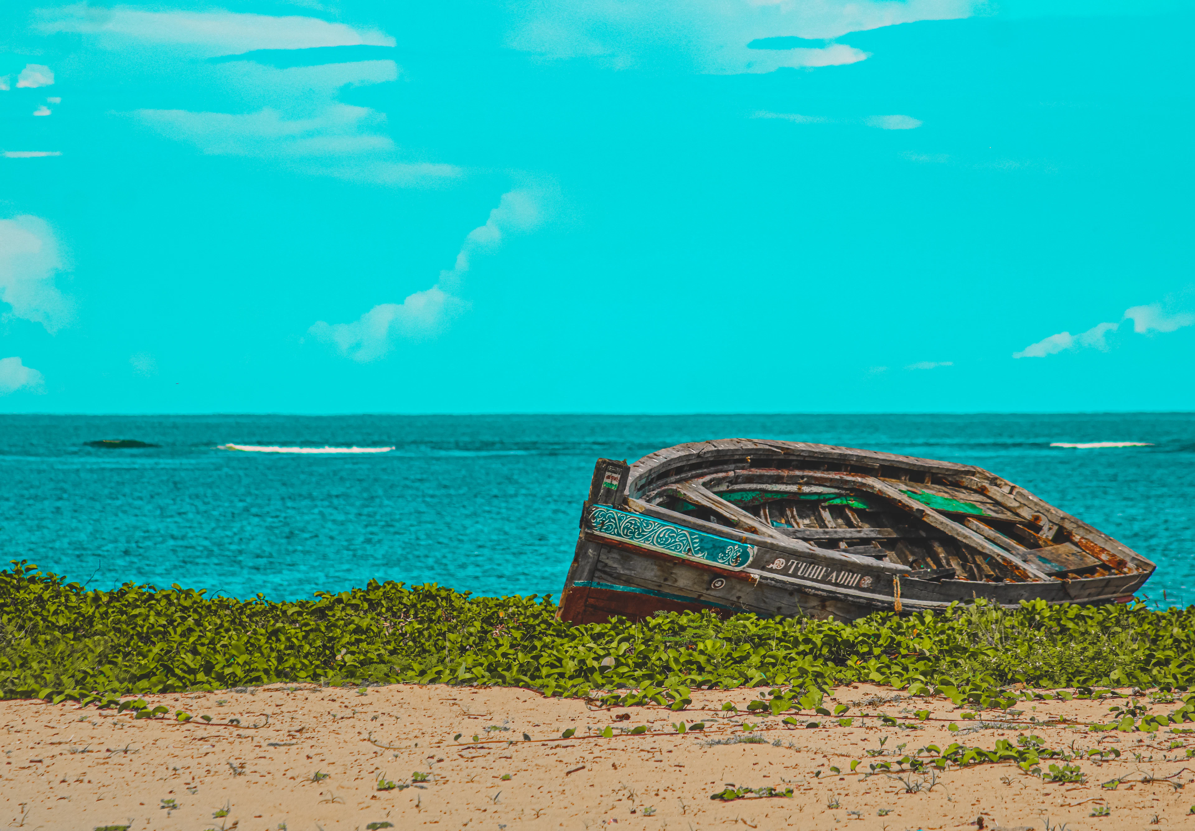 Wooden fishing boat resting on the sand