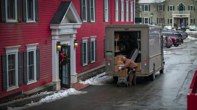 a person loading a van with flowers