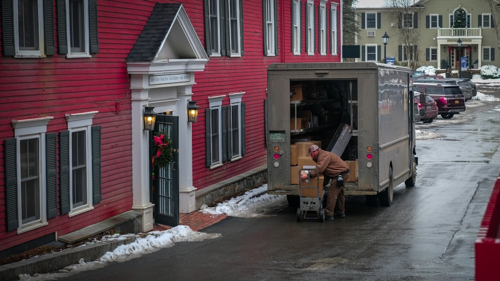 a person loading a van with flowers