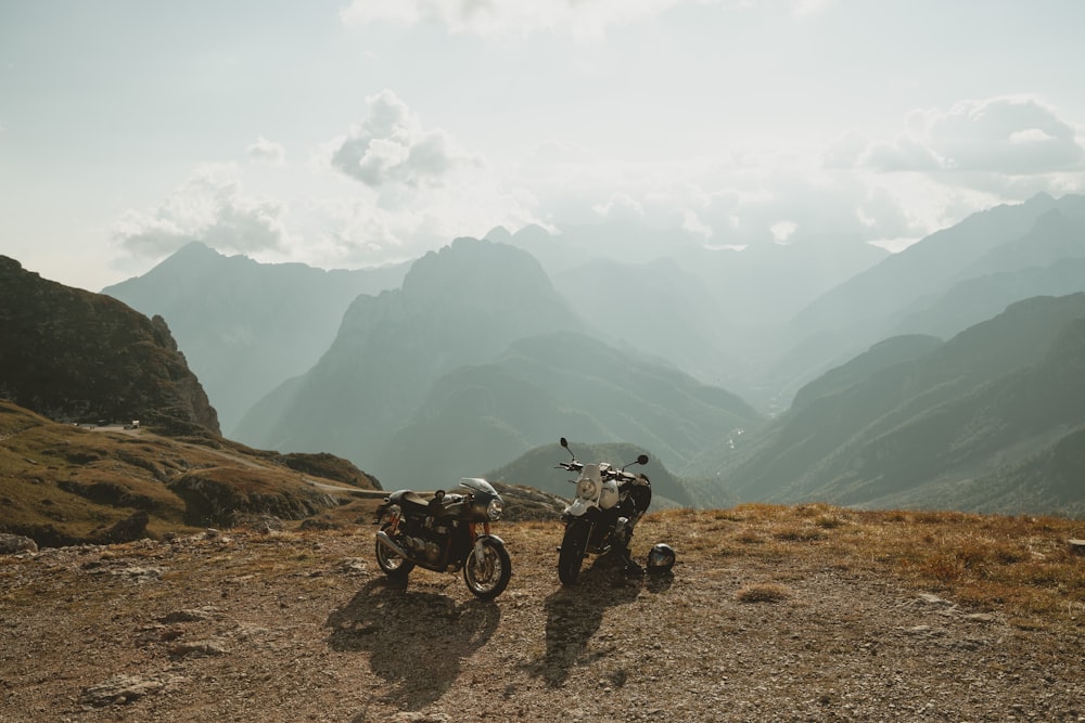 two motorcycles parked on a dirt road