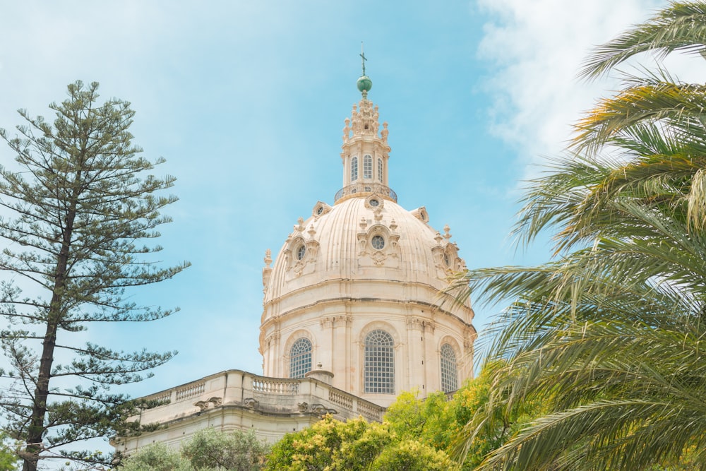 a building with a domed roof and trees in front of it