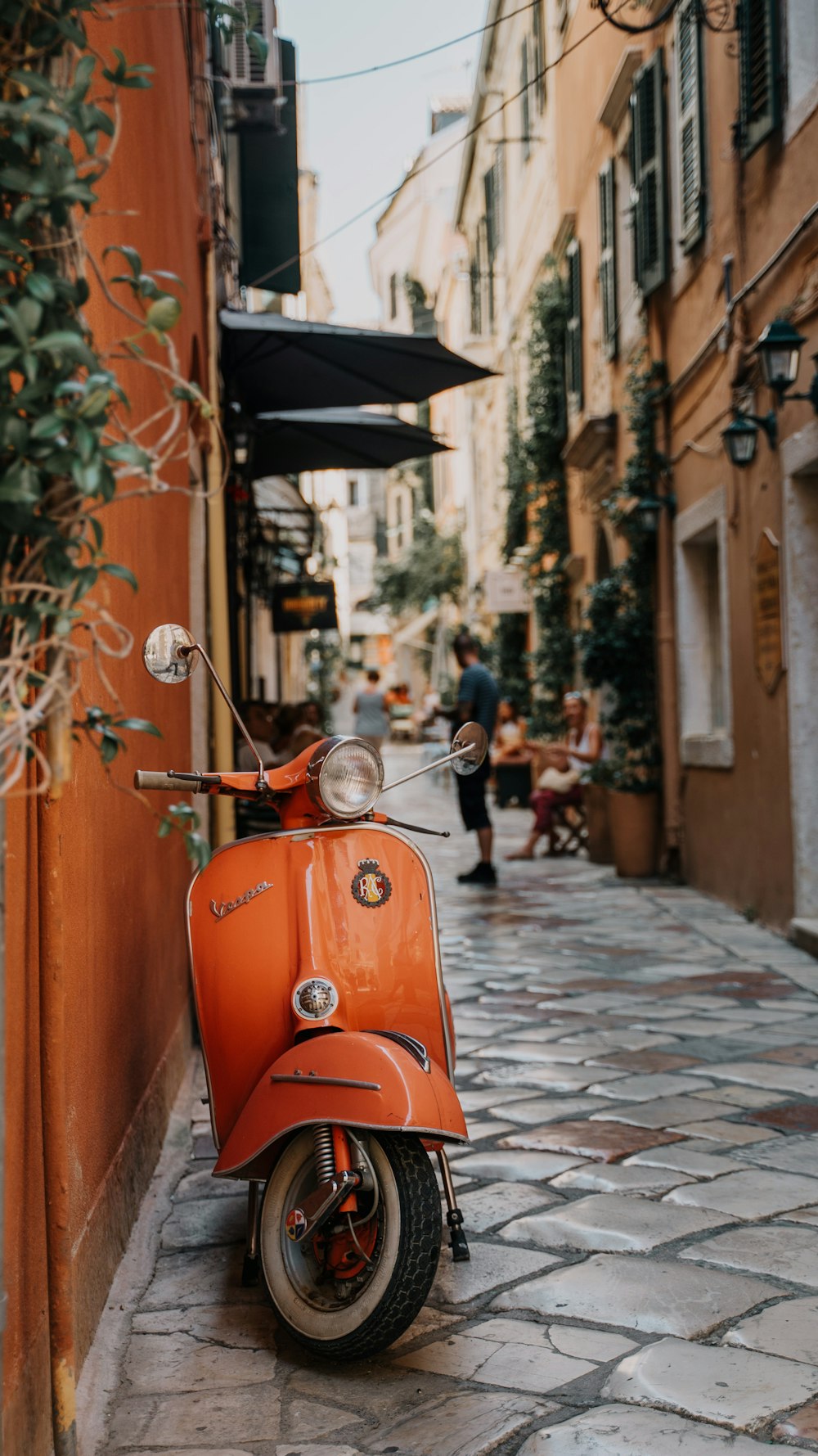 a scooter parked on a cobblestone street