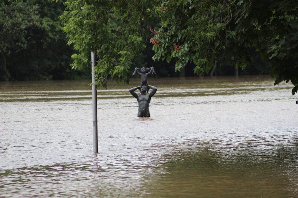 a statue in a flooded area