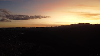 Sunset view of downtown Phoenix skyline with the desert mountains in the background.