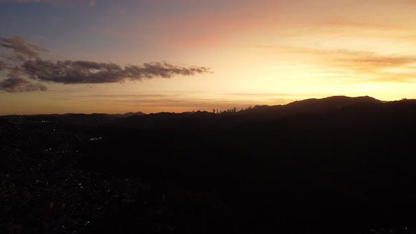 Sunset view of downtown Phoenix skyline with the desert mountains in the background.