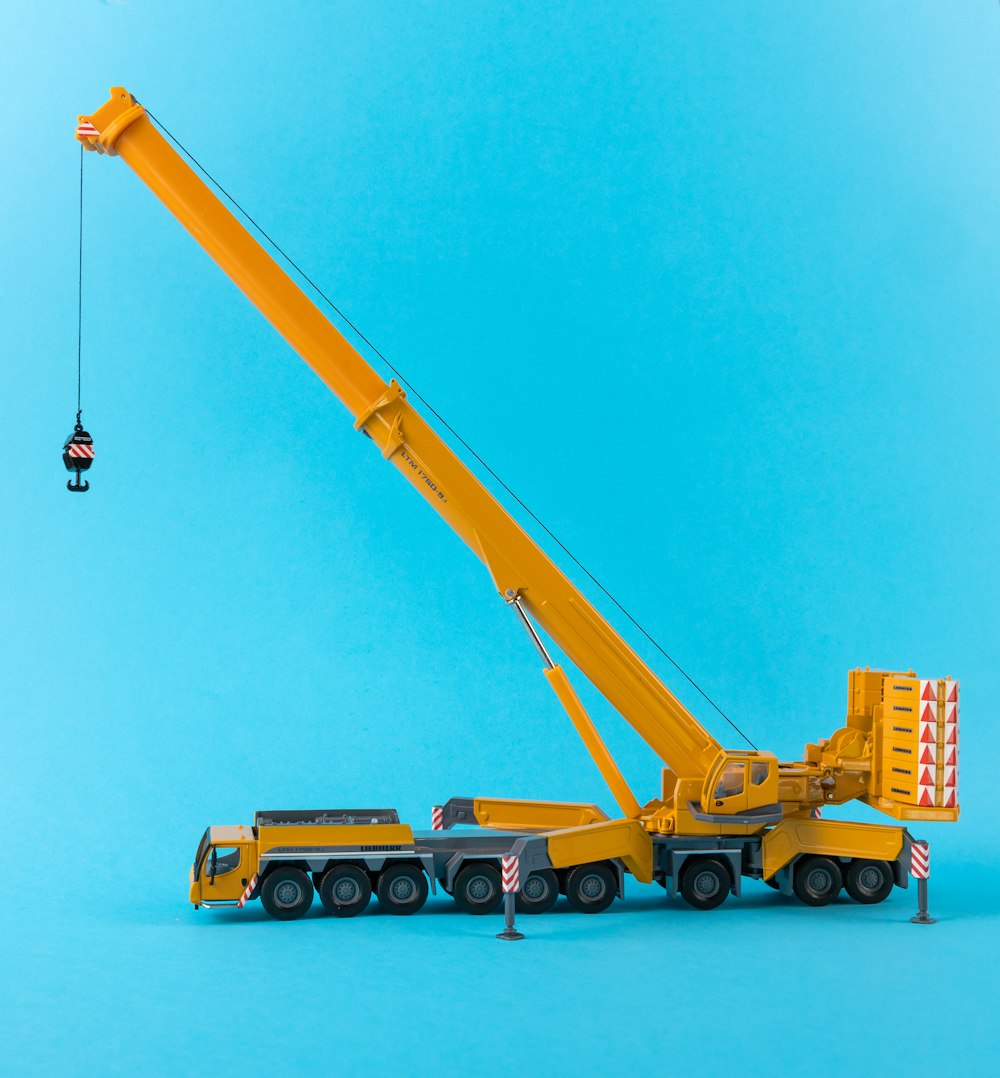 a yellow crane lifting a container