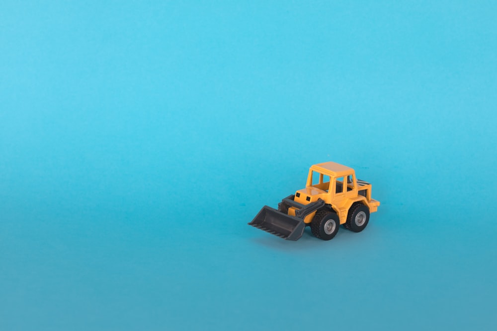 a toy truck on a blue surface