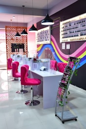 a pink chair in a room with a table and chairs