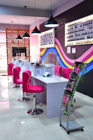 a pink chair in a room with a table and chairs