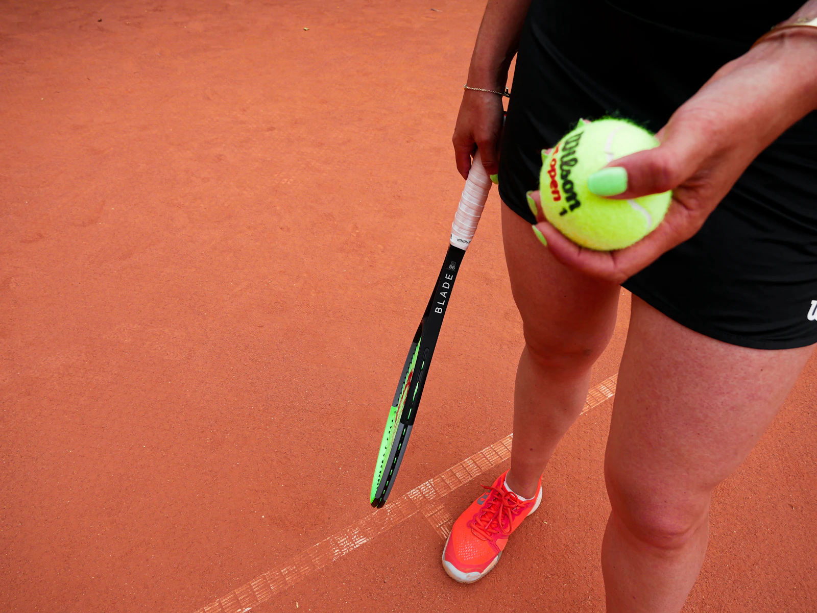 A player holding a tennis ball before a serve