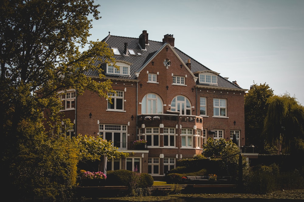 a large brick building with trees in front of it