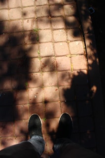 Happy customer wearing Magic Footware shoes while walking in a sunny park.