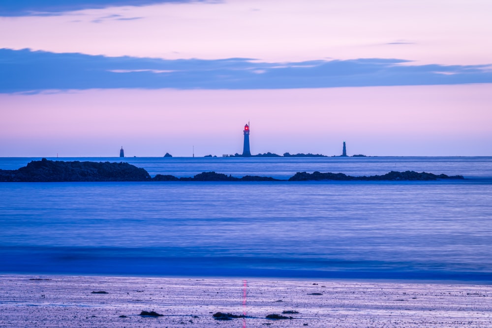 a body of water with a lighthouse in the distance