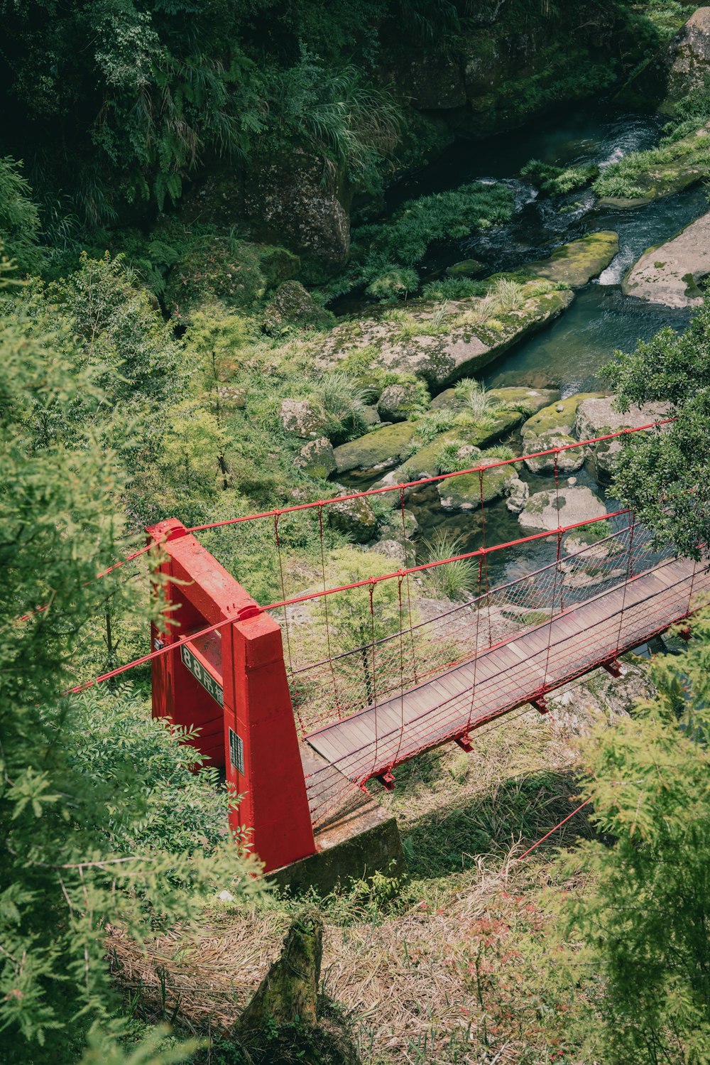 a red bridge over a river