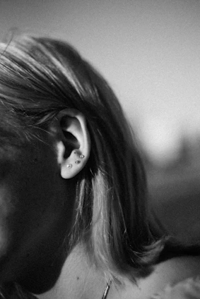 a woman with her earring in her ear