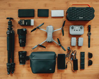 Various drone accessories neatly arranged on a wooden table.