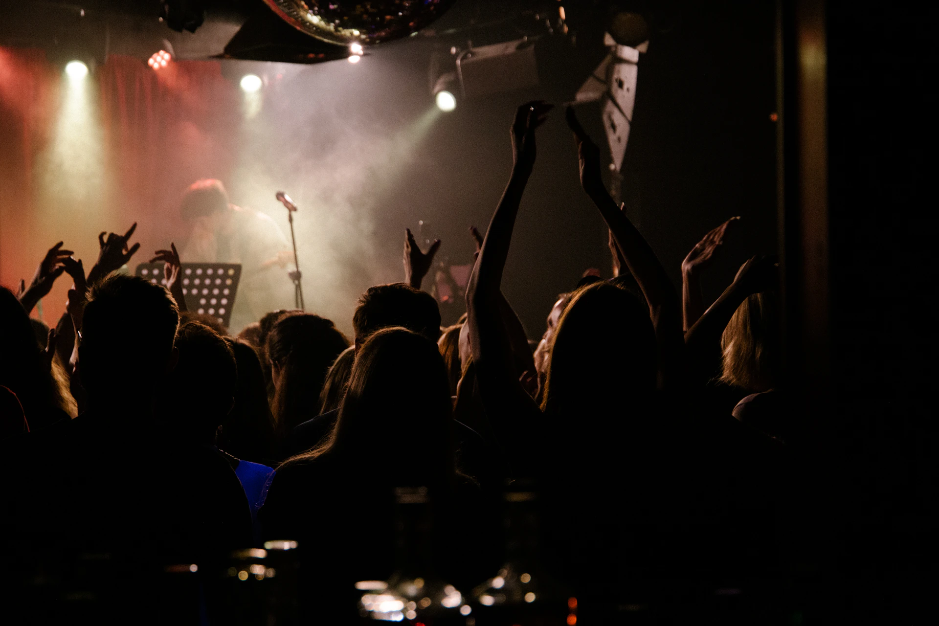 a person on a stage with a crowd watching