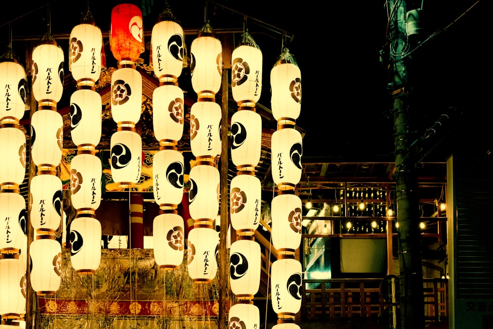 a group of white lanterns from a pole